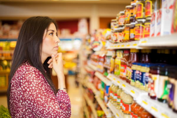 woman trying to figure out groceries at Walmart